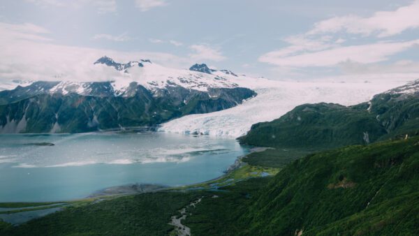 Aialik Glacier plunging into the ocean seen from a scenic flight over Kenai Fjords National Park in Seward, Alaska